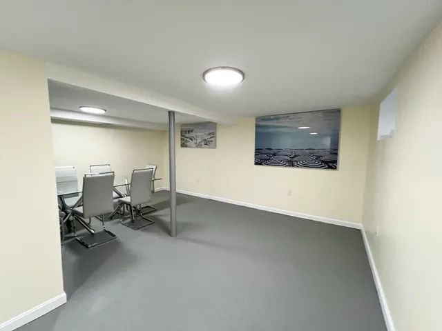 a view of a big room with lounge chair and windows