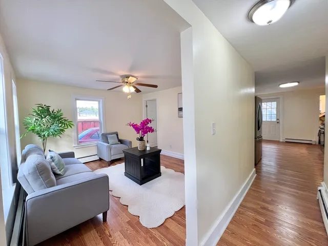a living room with furniture and a potted plant