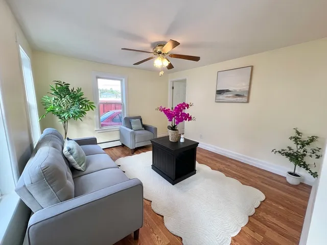 a living room with furniture and flowers