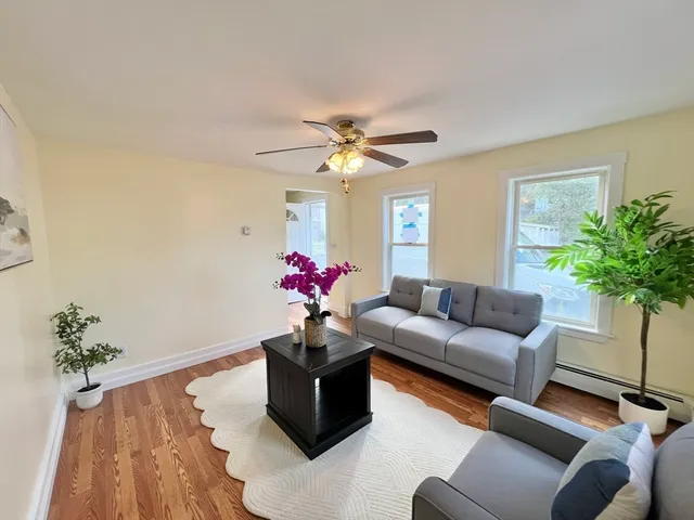 a living room with furniture flowers and a chandelier