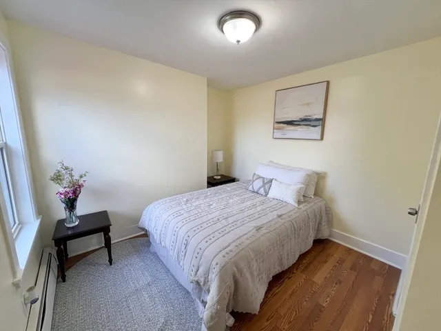 a bedroom with a bed and a painting on the wall