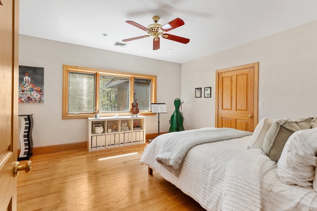 16 Solomon Pierce Road Lexington, MA 02420 - Photo 32 of 42 a bedroom with a large bed and a large window