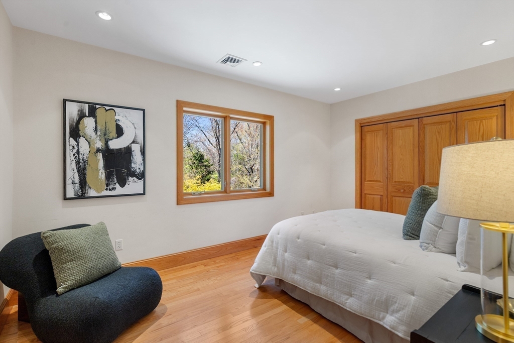 16 Solomon Pierce Road Lexington, MA 02420 - Photo 34 of 42 a bedroom with a bed and wooden floor