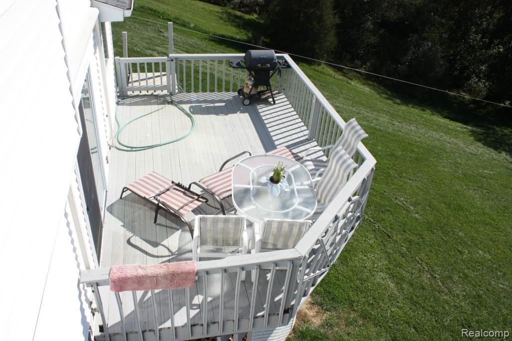5067 Mason Road Howell, MI 48843 - Photo 8 of 43 large deck off dining room overlooks acres of rolling hills with awning.