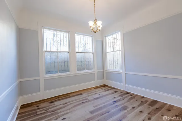 a view of wooden floor and windows in a room