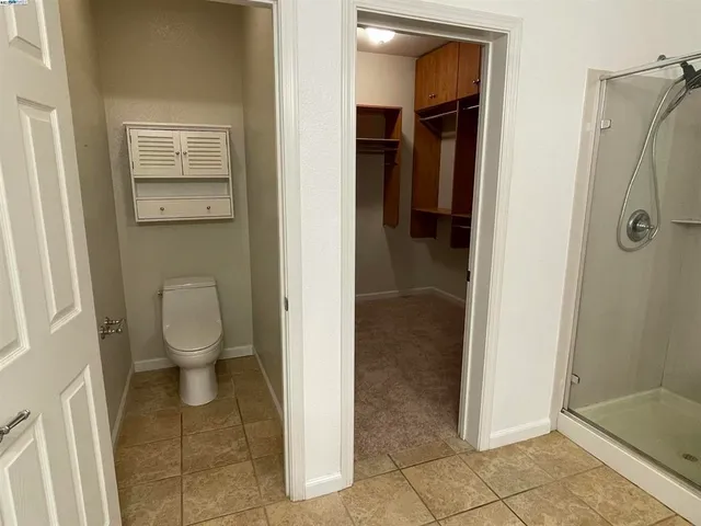 a bathroom with a toilet and a shower