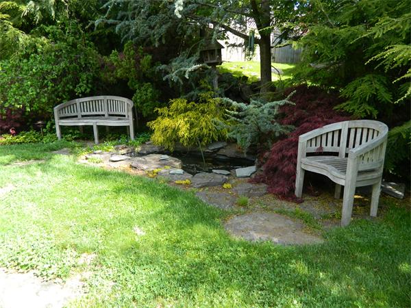 17 Sagamore Road Marblehead, MA 01945 - Photo 19 of 21 a view of a wooden deck with a bench and a yard
