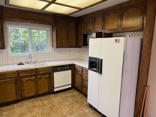 a kitchen with granite countertop cabinets and steel stainless steel appliances