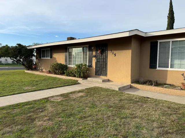an empty room with a fireplace and fan