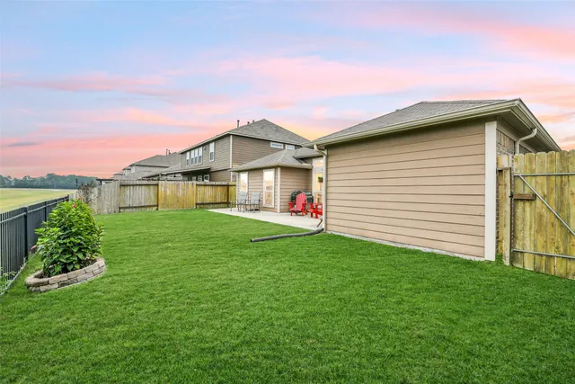 a view of a house with a yard and a garden