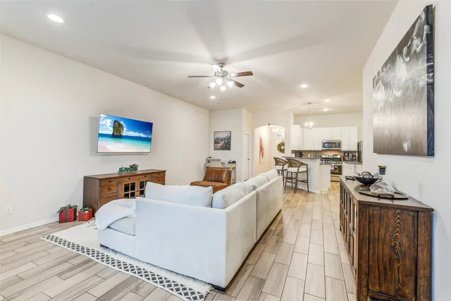 a living room with furniture and a chandelier