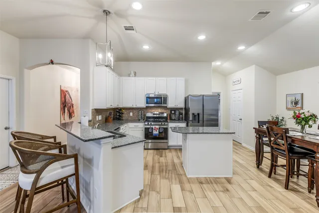 a kitchen with a table and chairs in it