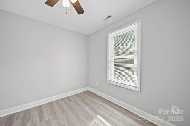 a bathroom with a granite countertop sink and a mirror a toilet