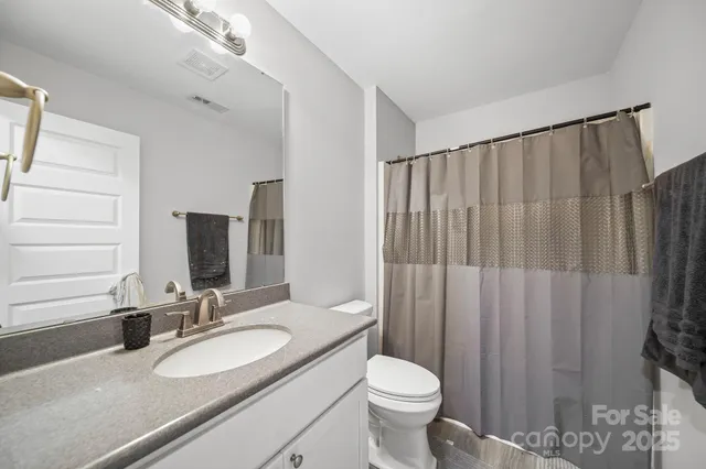 a bathroom with a sink a toilet and mirror