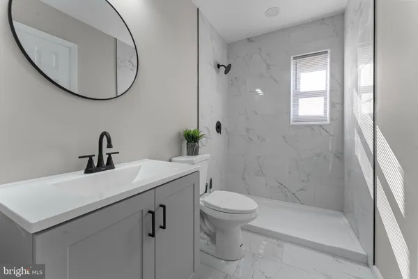 a bathroom with a sink a toilet and a mirror