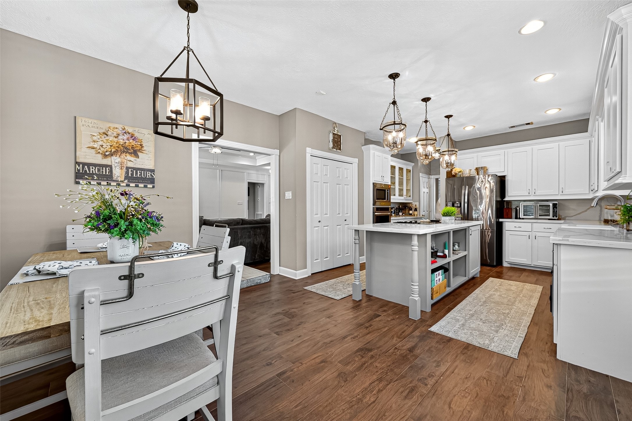 5911 Springton Lane Spring, TX 77379 - Photo 13 of 43 a kitchen with stainless steel appliances kitchen island granite countertop a table and chairs in it