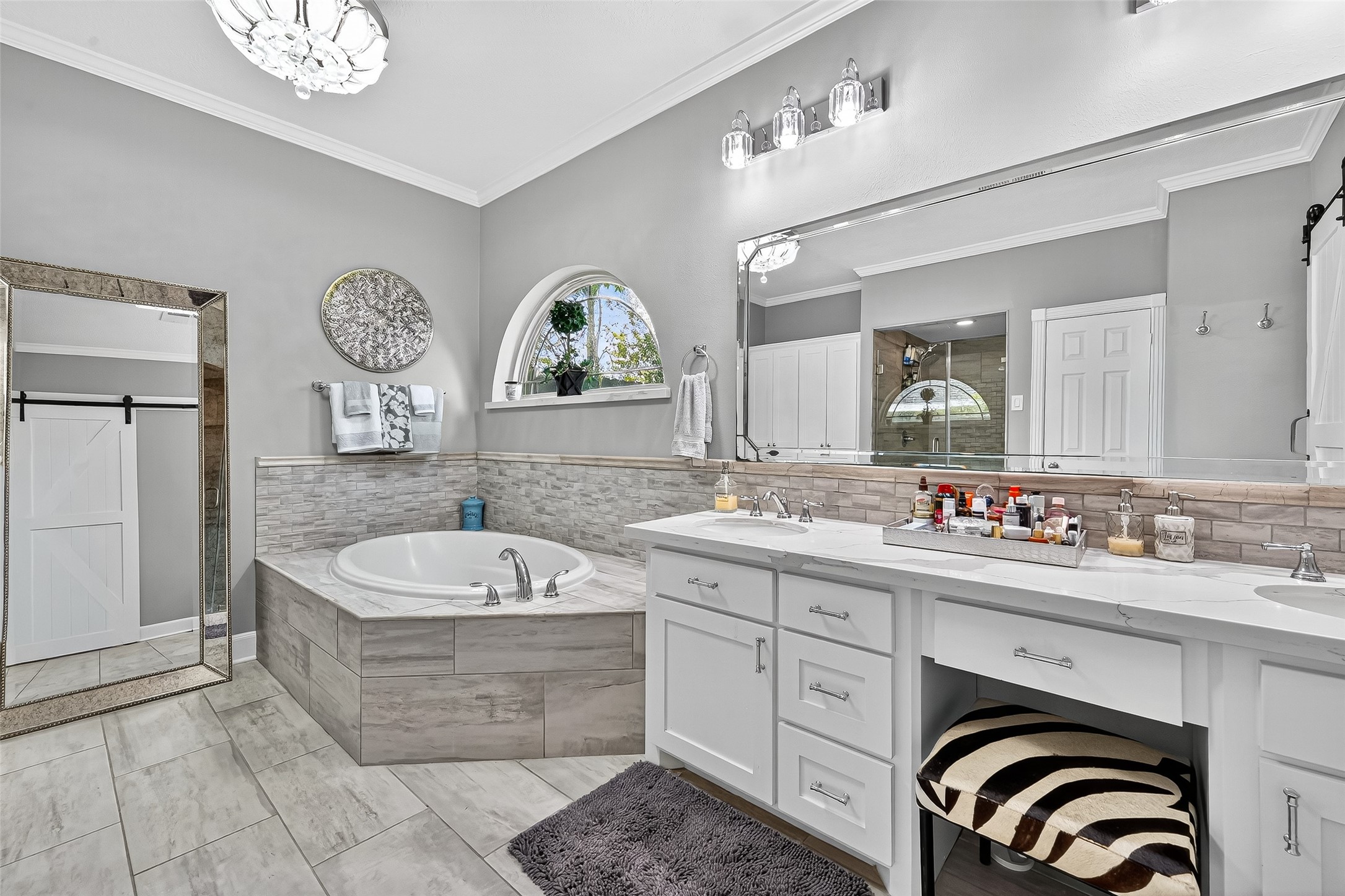 5911 Springton Lane Spring, TX 77379 - Photo 23 of 43 a spacious bathroom with a sink a bathtub and a mirror