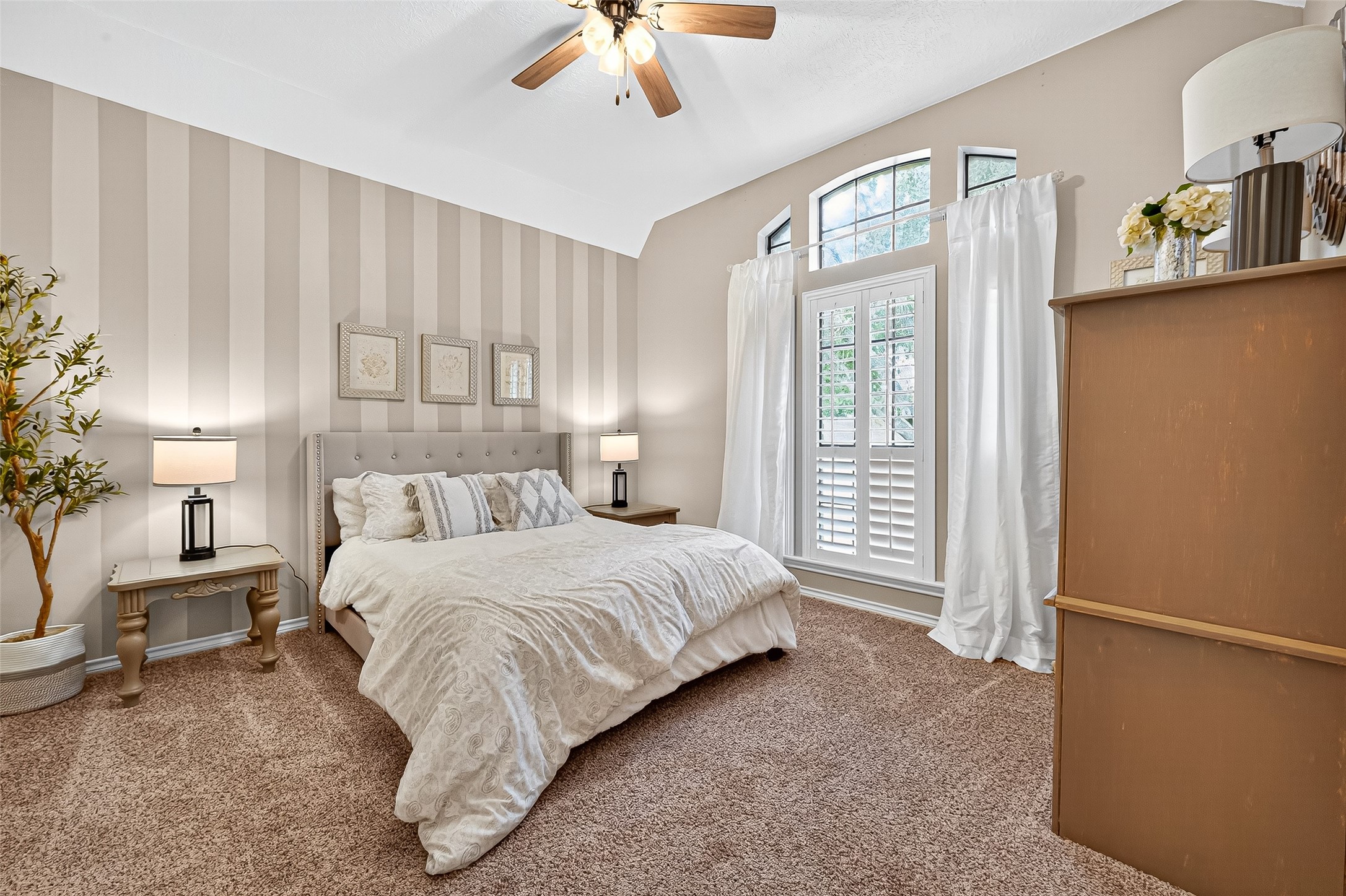 5911 Springton Lane Spring, TX 77379 - Photo 26 of 43 a bedroom with a large bed and a chandelier