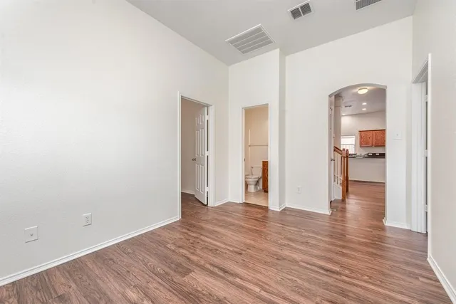 a view of a hallway with wooden floor