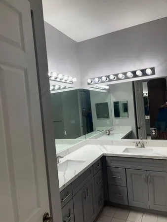 a bathroom with a double vanity sink and mirror