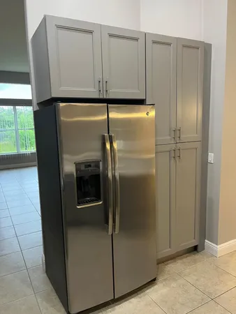 a view of cabinets with a refrigerator