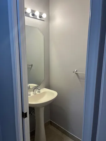 a bathroom with a sink a mirror and a toilet