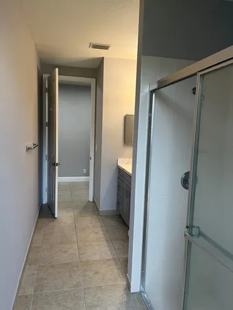 a bathroom with a shower and a glass door