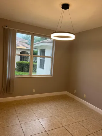 an empty room with a table and chandelier