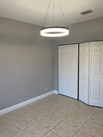 a view of a livingroom with a ceiling fan and window