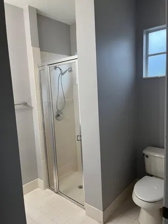 a close view of a sink and dishwasher with wooden cabinets