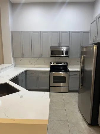 a kitchen with a sink a stove and refrigerator