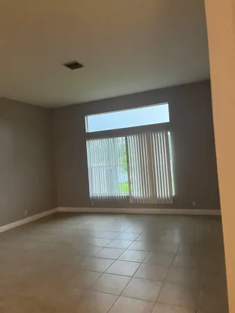 an empty room with large window