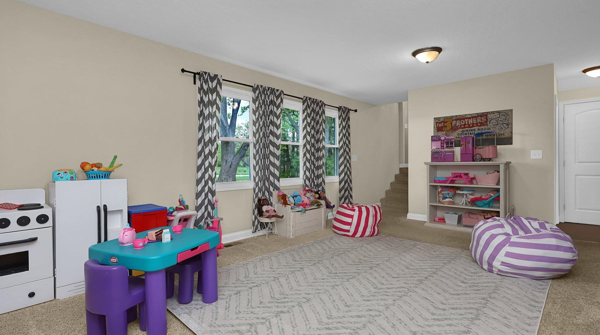 7790 Schott Road Westerville, OH 43081 - Photo 30 of 50 stairs and you'll find yourself in a family room. Currently being used as a HUGE play area, you'll enjoy EVERY minute in this wonderful space!