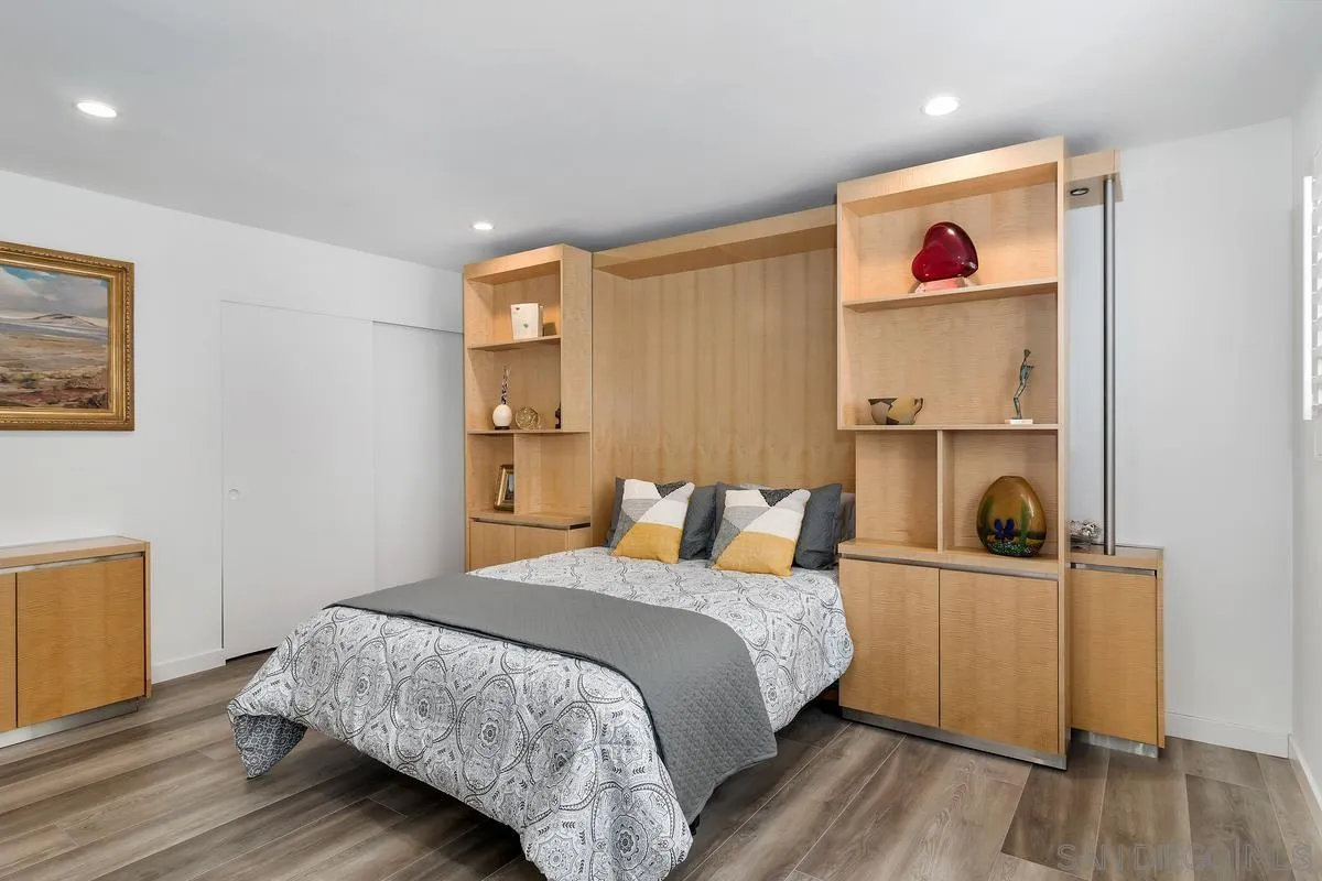 100 Coast Boulevard, Unit 304 La Jolla, CA 92037 - Photo 15 of 36 a bedroom with a bed and wooden floor