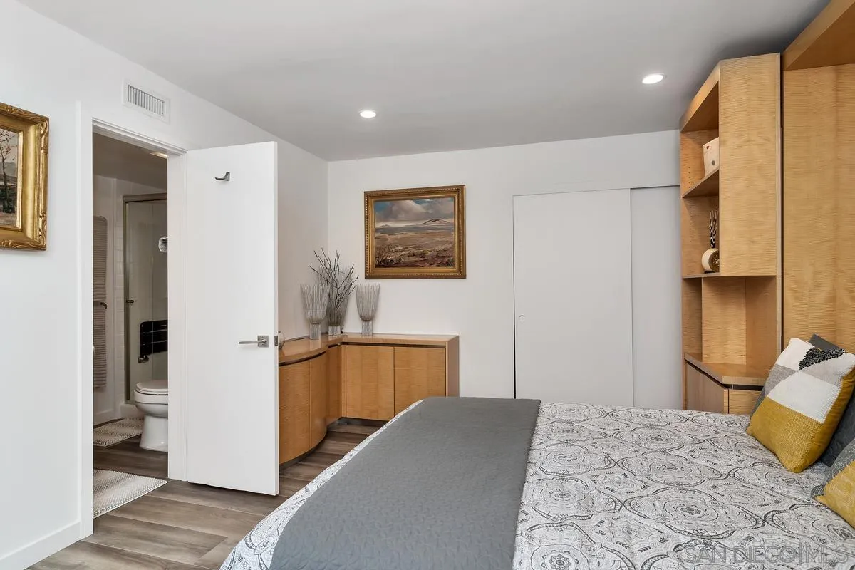 100 Coast Boulevard, Unit 304 La Jolla, CA 92037 - Photo 16 of 36 a bedroom with a bed and a refrigerator