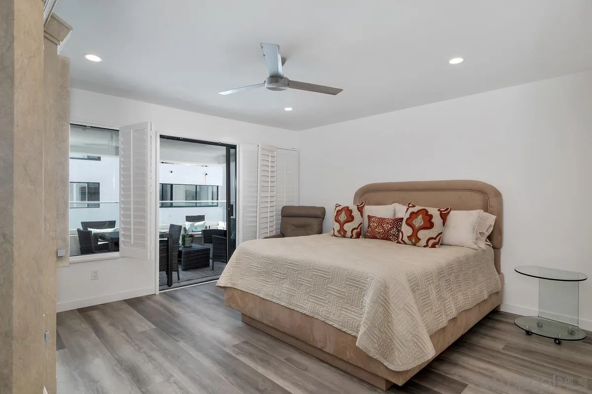 100 Coast Boulevard, Unit 304 La Jolla, CA 92037 - Photo 20 of 36 a bedroom with a large bed and a view of living room