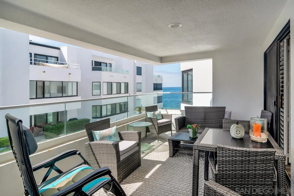 100 Coast Boulevard, Unit 304 La Jolla, CA 92037 - Photo 25 of 36 a living room with furniture a rug and a table
