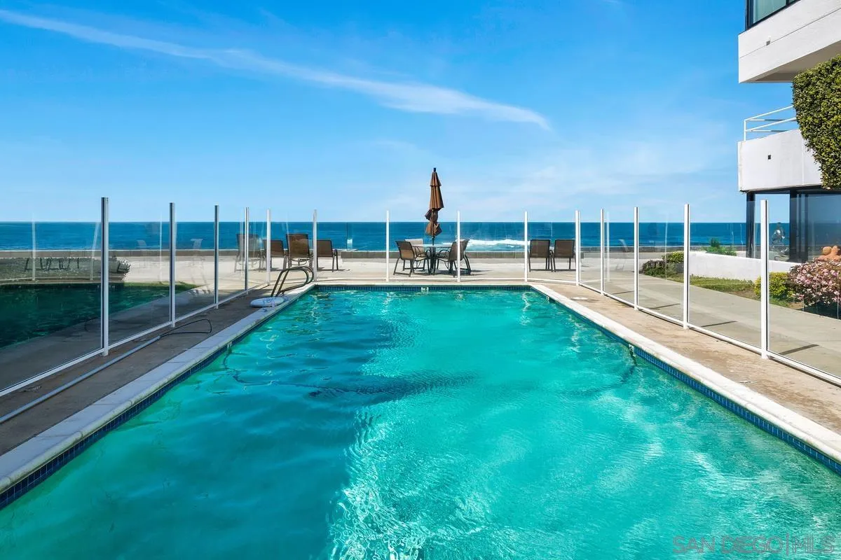 100 Coast Boulevard, Unit 304 La Jolla, CA 92037 - Photo 33 of 36 a view of a swimming pool with a chair and tables
