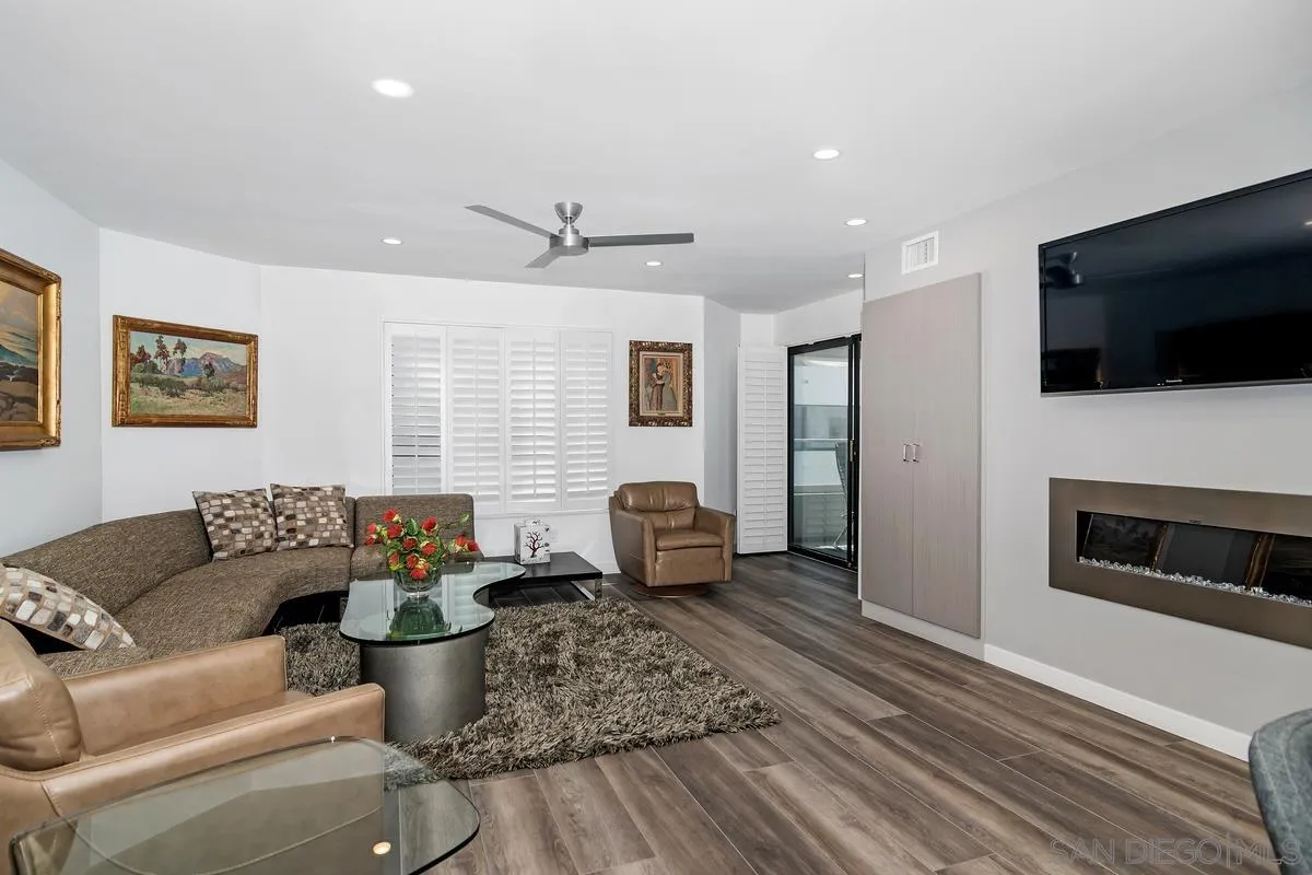 100 Coast Boulevard, Unit 304 La Jolla, CA 92037 - Photo 7 of 36 a living room with furniture a flat screen tv and kitchen view