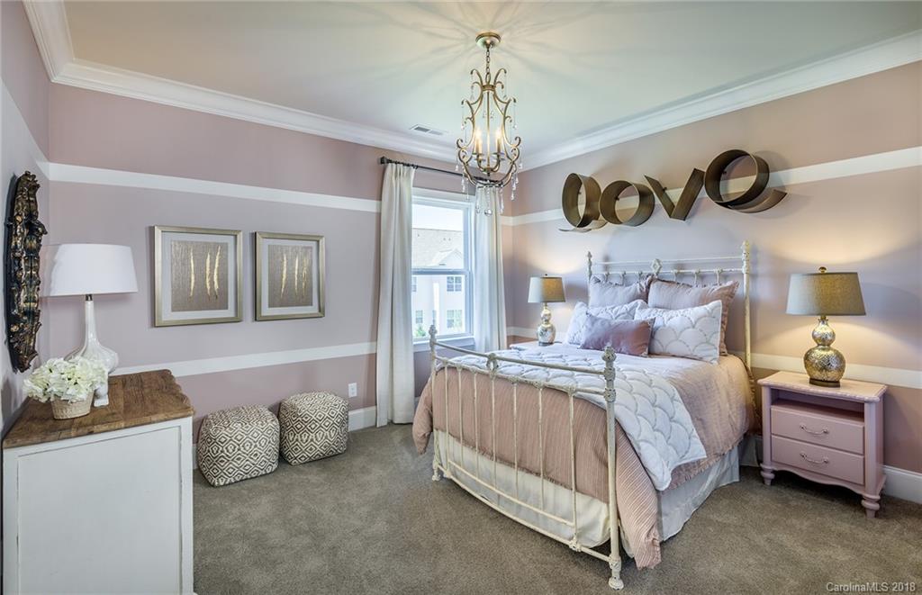 2222 Watermark Point Place Fort Mill, SC 29708 - Photo 17 of 24 a bedroom with a bed and a chandelier