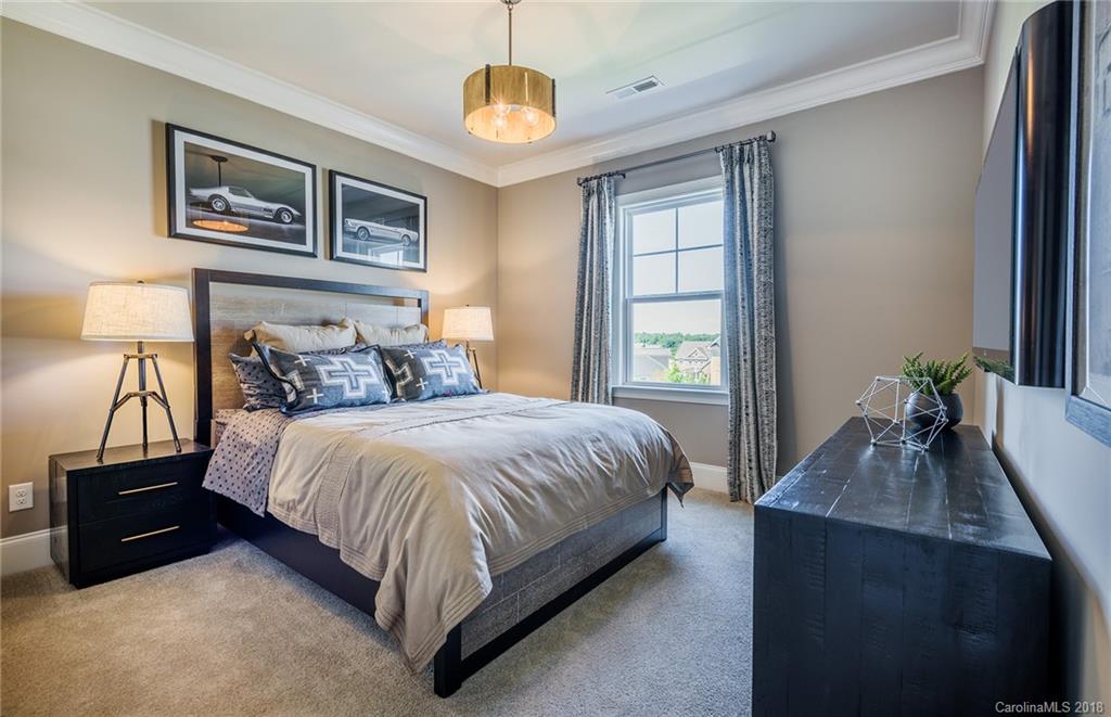 2222 Watermark Point Place Fort Mill, SC 29708 - Photo 19 of 24 a spacious bedroom with a bed and a chandelier