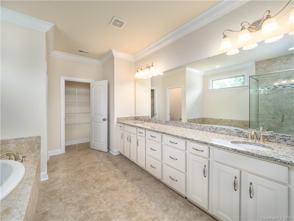 2222 Watermark Point Place Fort Mill, SC 29708 - Photo 22 of 24 a spacious bathroom with a granite countertop sink mirror and a