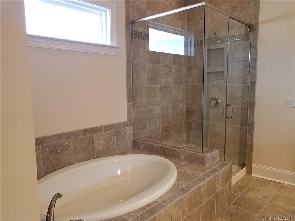2222 Watermark Point Place Fort Mill, SC 29708 - Photo 23 of 24 a bathroom with a tub and shower