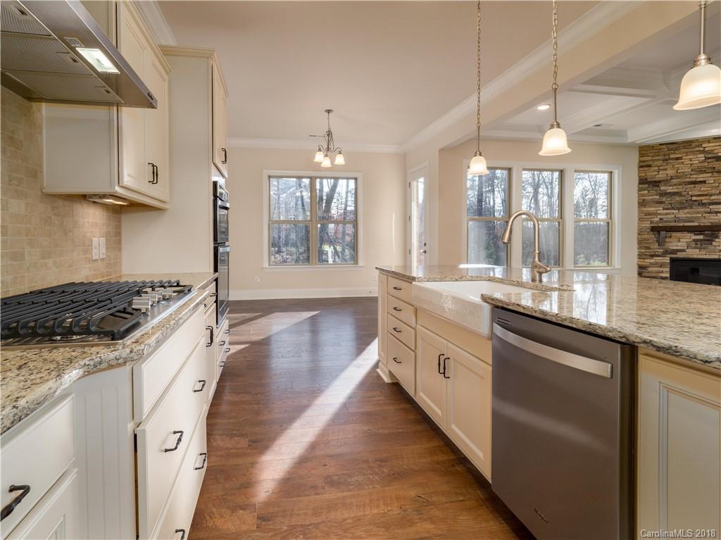 2222 Watermark Point Place Fort Mill, SC 29708 - Photo 7 of 24 a large kitchen with granite countertop a sink and cabinets