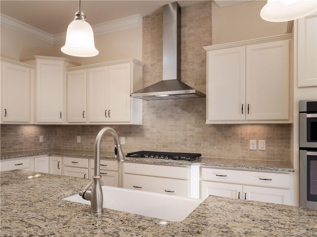 2222 Watermark Point Place Fort Mill, SC 29708 - Photo 8 of 24 a kitchen with granite countertop white cabinets and a stove
