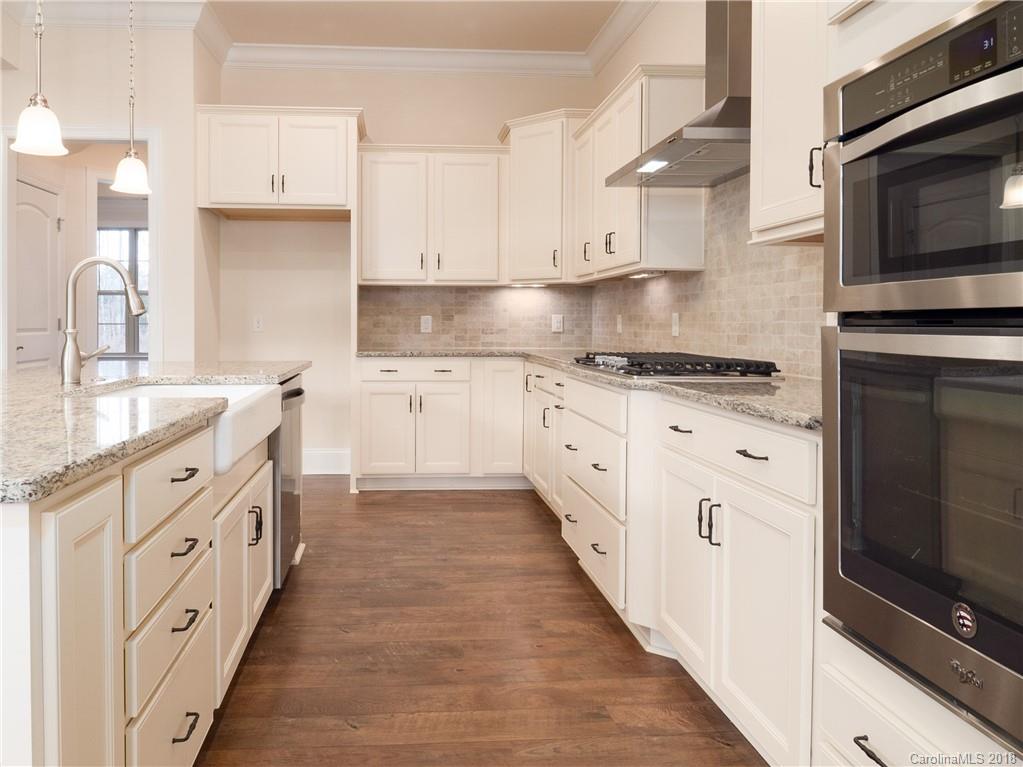 2222 Watermark Point Place Fort Mill, SC 29708 - Photo 9 of 24 a kitchen with granite countertop a sink and a stove top oven
