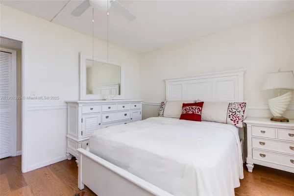 a bedroom with a large bed and a large window