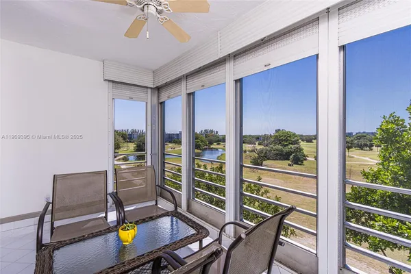 a view of a chairs and table in patio with a lake view
