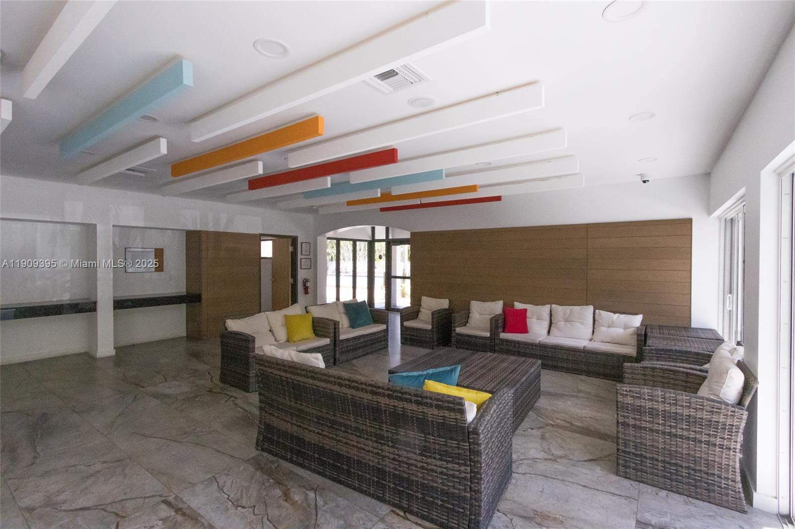 2671 South Course Drive, Unit 506 Pompano Beach, FL 33069 - Photo 30 of 31 a living room with furniture and a flat screen tv