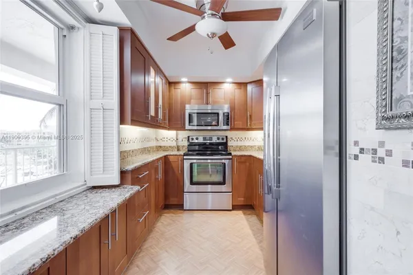 a kitchen with granite countertop cabinets and stainless steel appliances